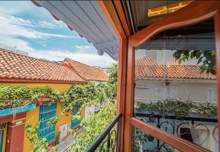 View of tiled roofs from a colonial wooden balcony