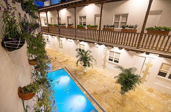 Lit pool between white colonial balconies